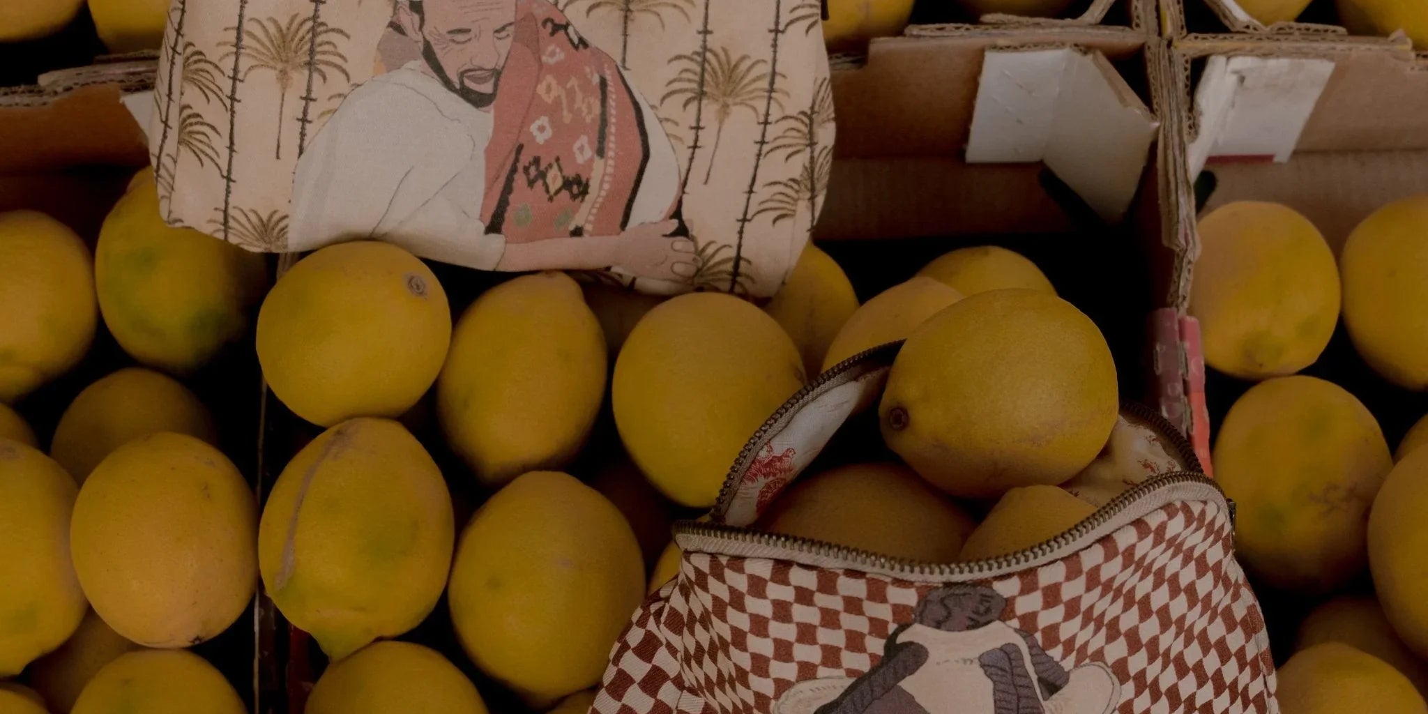 Ethnik Moroccan illustrated pouches displayed on fresh yellow lemons in market setting