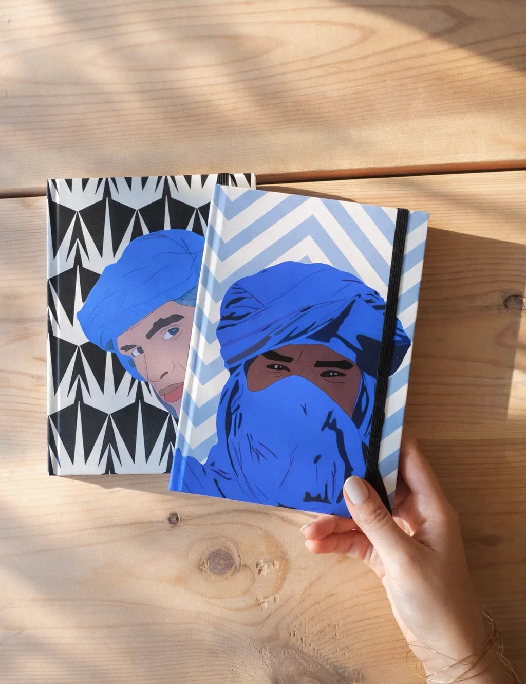 Ethnik Moroccan illustrated notebooks with blue turban designs on wooden table