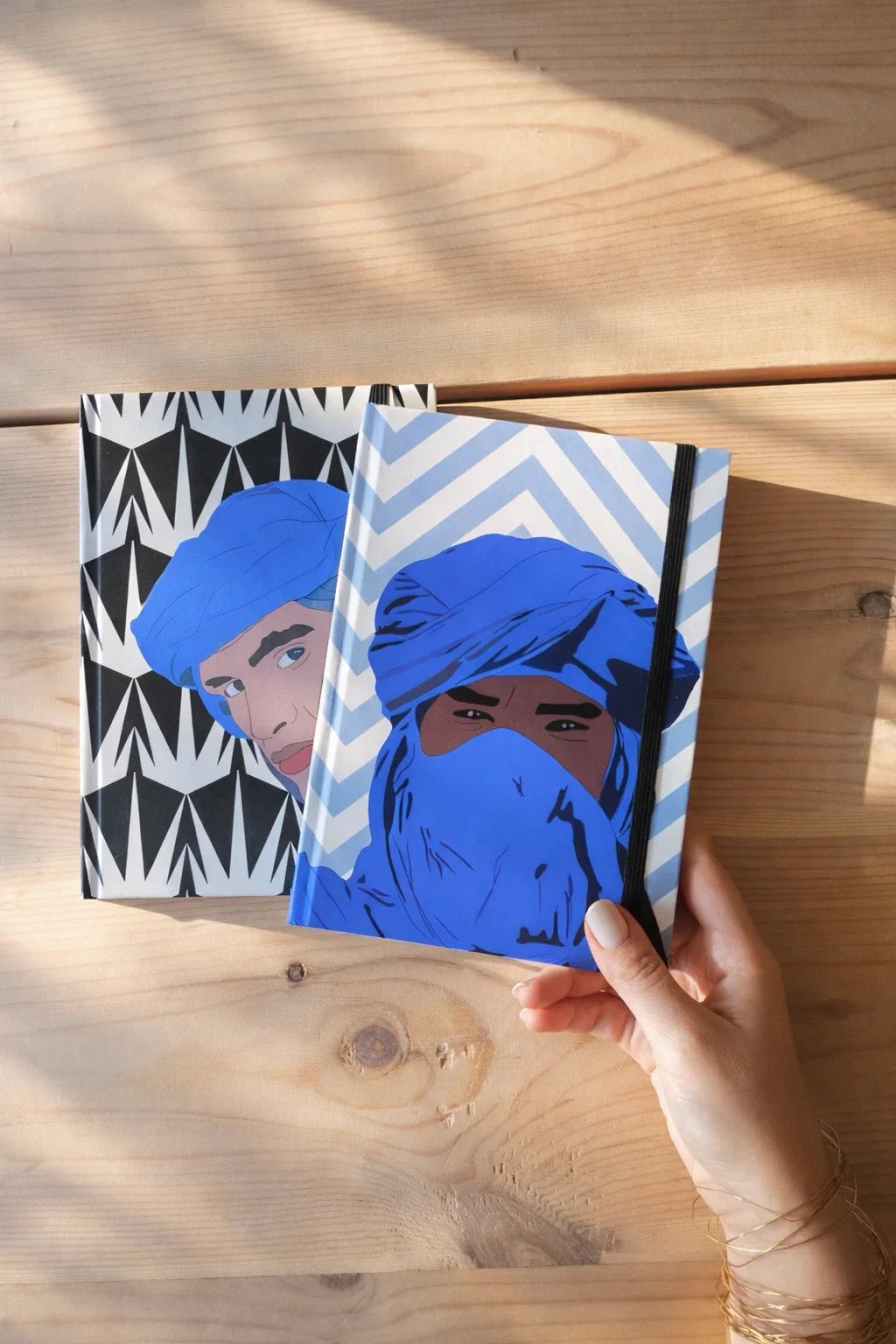 Ethnik Moroccan illustrated notebooks with blue turban designs on wooden table