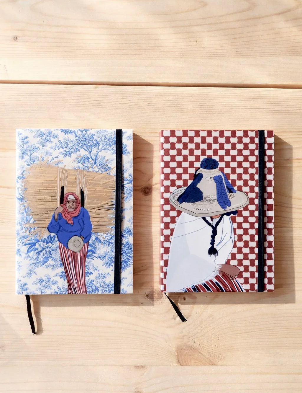 Two ethnik Moroccan notebooks with original illustrated covers on a wooden surface