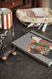 Ethnik Moroccan stationery set with illustrated notebook, striped mug, pouch, and colored pencils on table