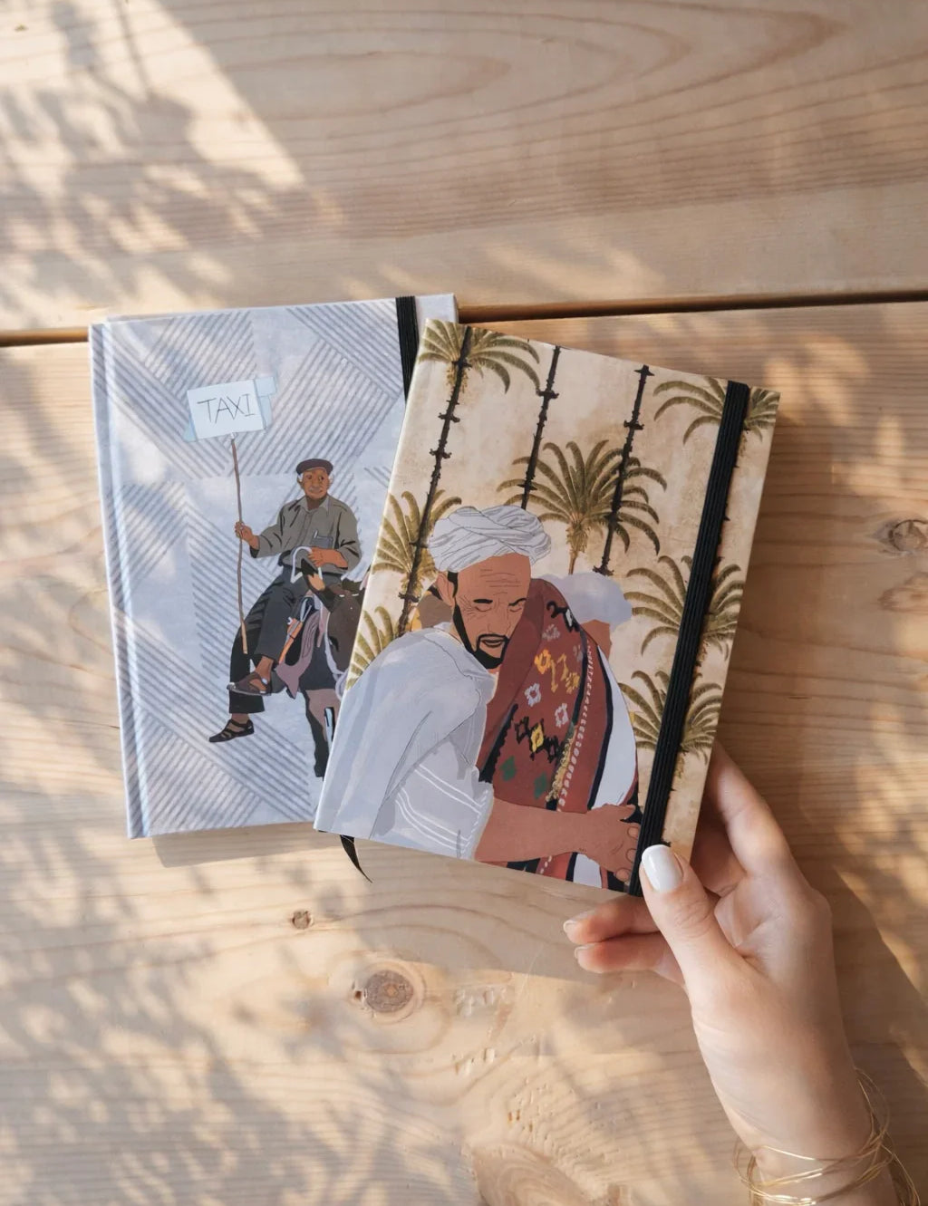 Ethnik Morocco illustration notebooks on wooden table, hand holding journal, stationery accessories