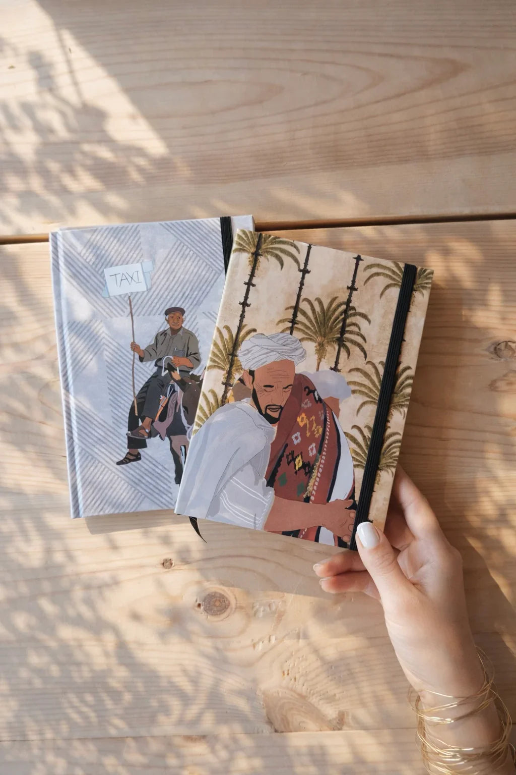 Ethnik Morocco illustration notebooks on wooden table, hand holding journal, stationery accessories