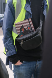 ethnik Moroccan illustrated notebook in black bag, person wearing blue jacket and yellow vest