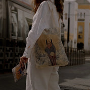 Woman outdoors with ethnik tote bag and notebook, featuring Moroccan illustration design.