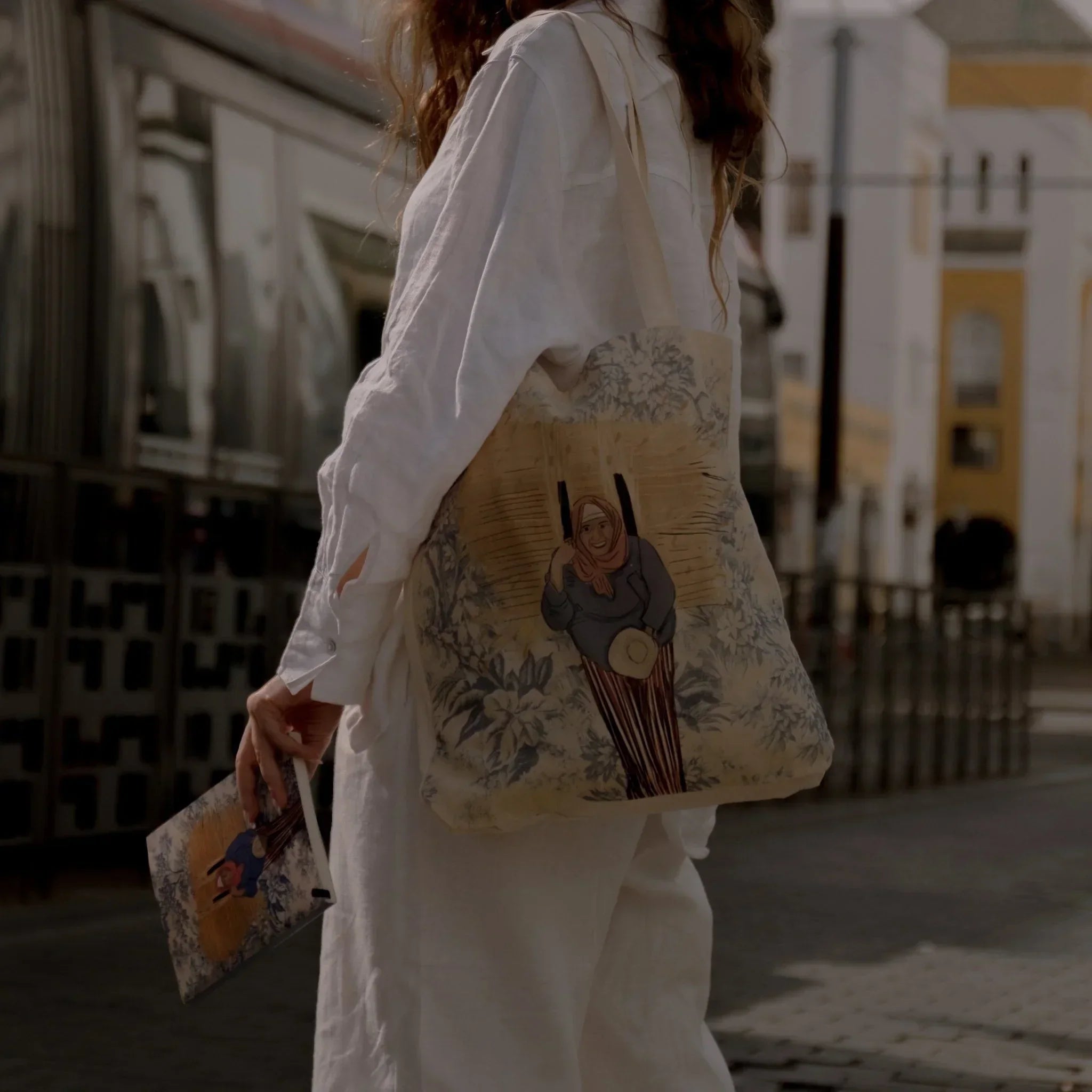 Woman outdoors with ethnik tote bag and notebook, featuring Moroccan illustration design.