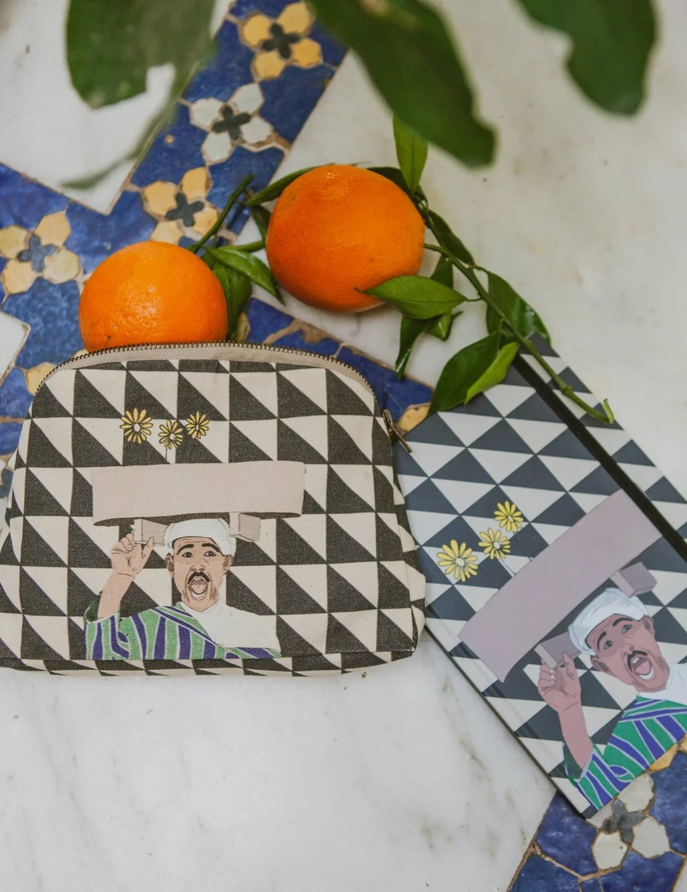 Ethnik Moroccan pouch and notebook with geometric pattern, illustrated man, and two oranges