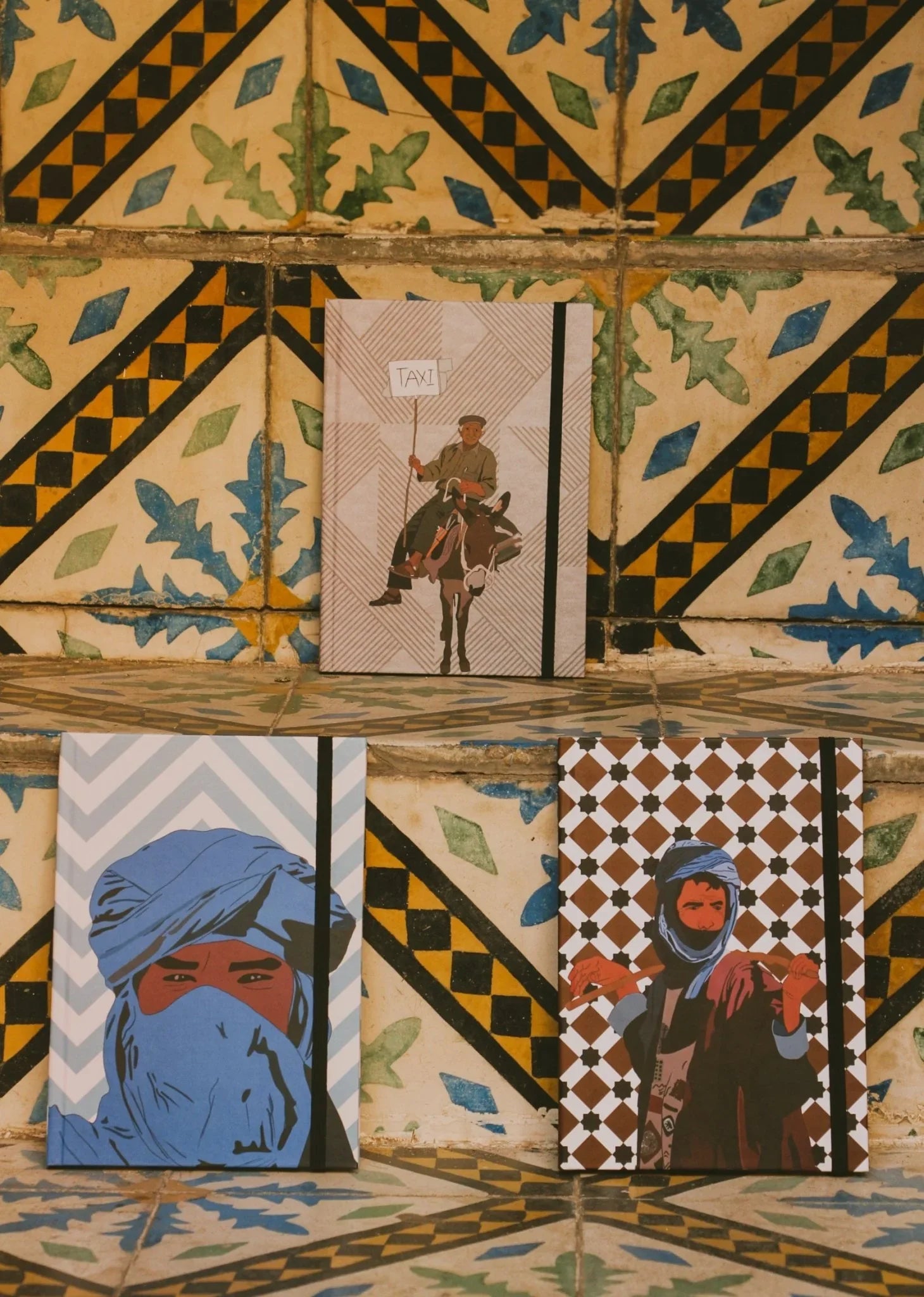 Ethnik Morocco illustrated notebooks with traditional covers on Moroccan tile background