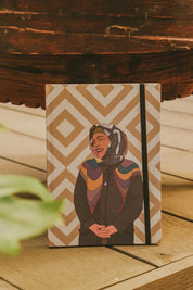 Ethnik Moroccan notebook with geometric cover and illustrated woman in headscarf, on wood table