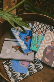 Ethnik Moroccan illustrated notebooks with colorful covers and geometric patterns on a wooden tray