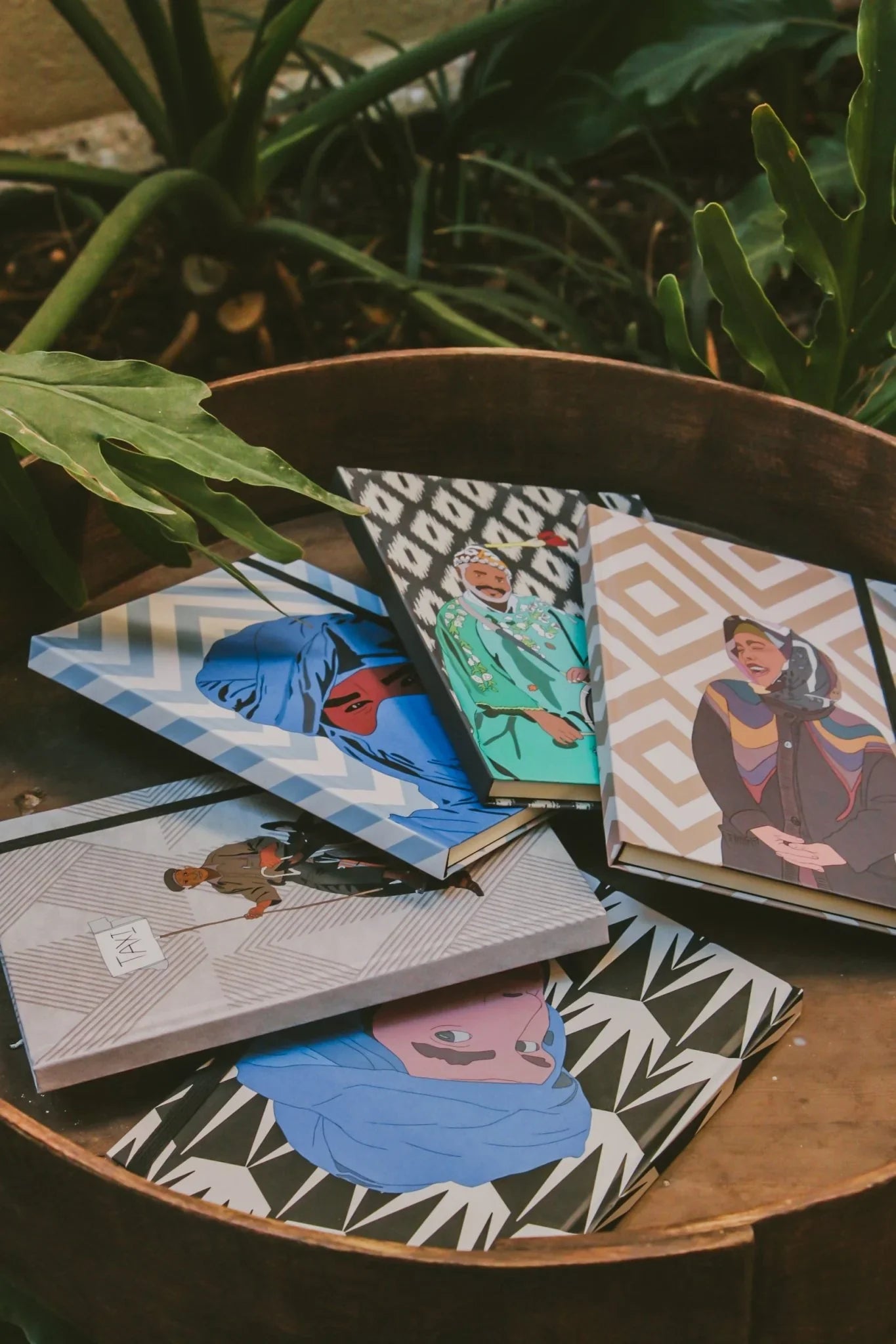 Ethnik Morocco illustrated notebooks with geometric patterns and portraits on a wooden table