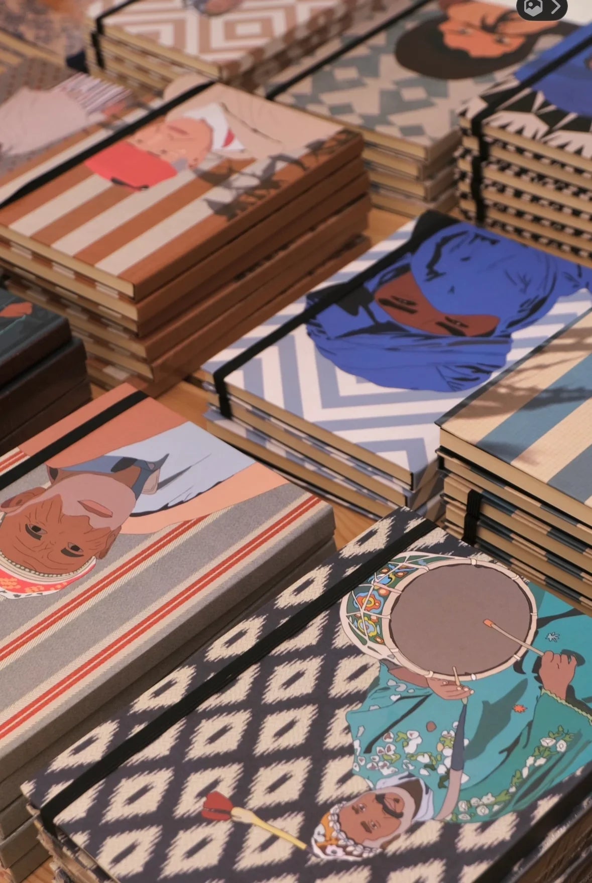 Stacked ethnik Moroccan notebooks with colorful illustrations and patterned covers