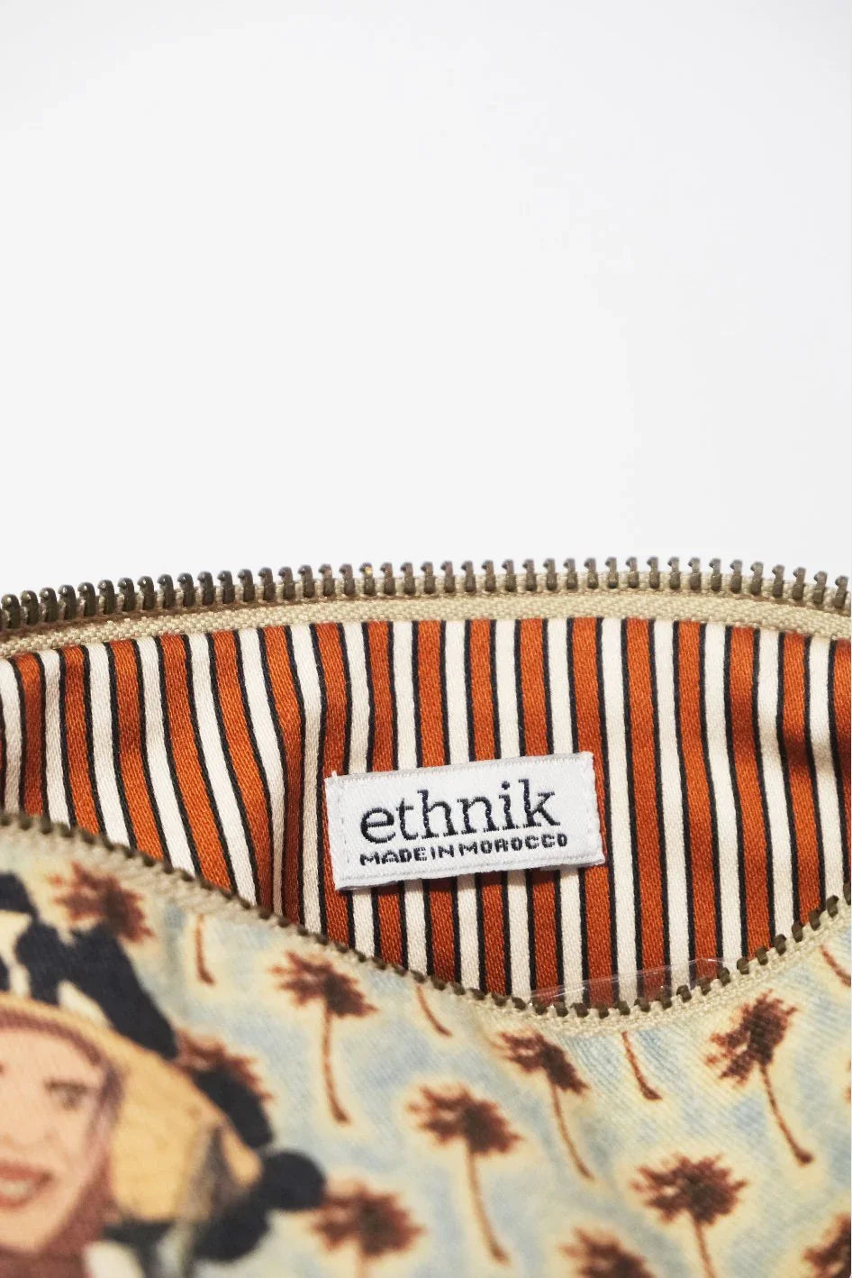 ethnik pouch with striped orange lining and 'Made in Morocco' label, palm tree pattern