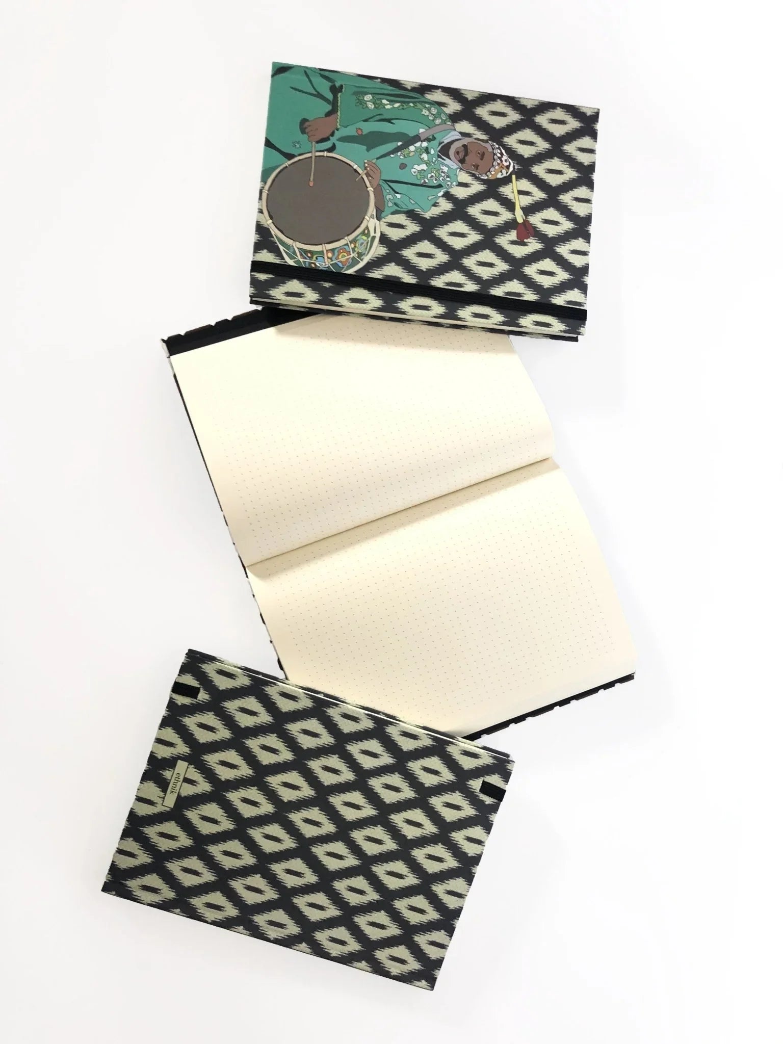 Ethnik Moroccan notebook with geometric cover and illustrated drummer, dotted pages inside