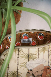 Ethnik Moroccan pouch with floral lining and illustrated design, plant in background