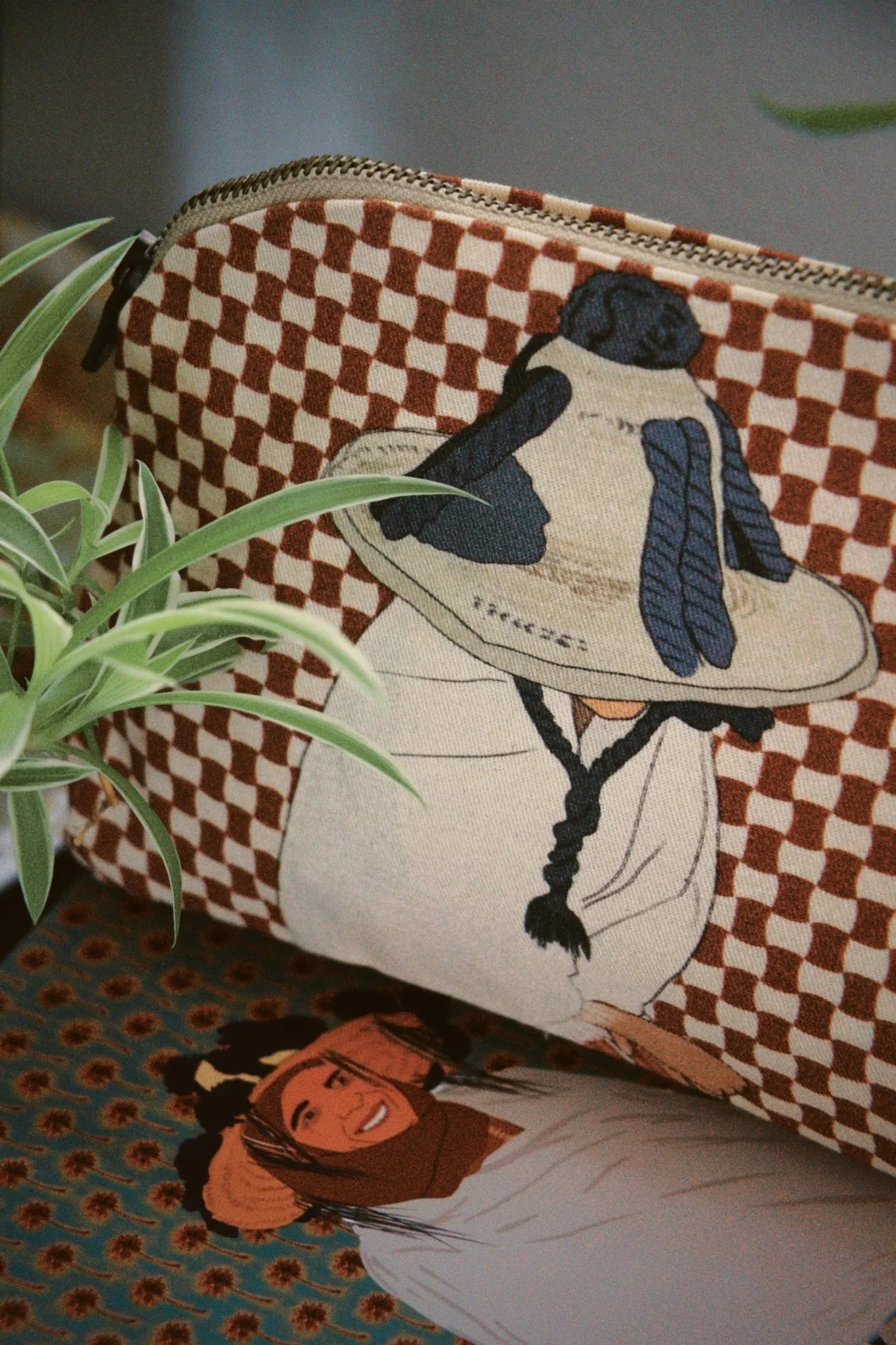 Moroccan illustrated zip pouch with checkered pattern by ethnik, shown with plant and matching card.