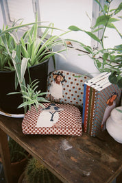 Ethnik Moroccan stationery and pouches with original illustrations on wooden table by plants