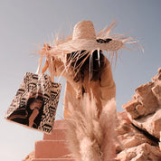 Woman in straw hat holding ethnik tote bag with Moroccan illustration outdoors