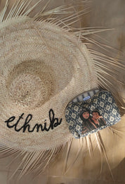 ethnik straw hat and Moroccan patterned pouch with illustration, natural background